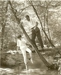 2351.5-508568 Couple Pauses Foot Bridge Twiddle Toes - Sam Houston National Forest 1964 by United States Forest Service